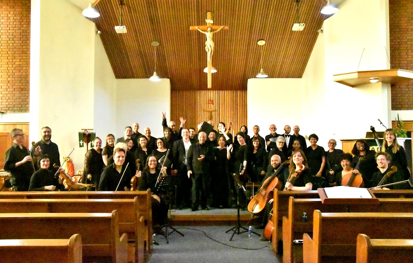 Choir and instrumentalists gathered together after a performance