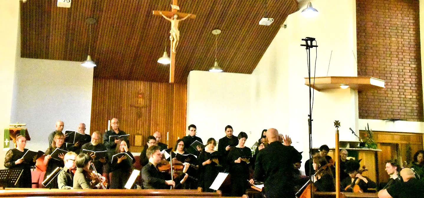 Choir and instrumentalists performing together in a church sanctuary