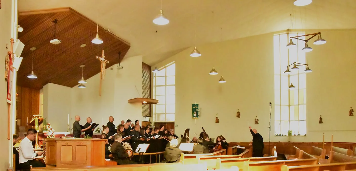 Choir and instrumentalists seen across the church sanctuary during performance